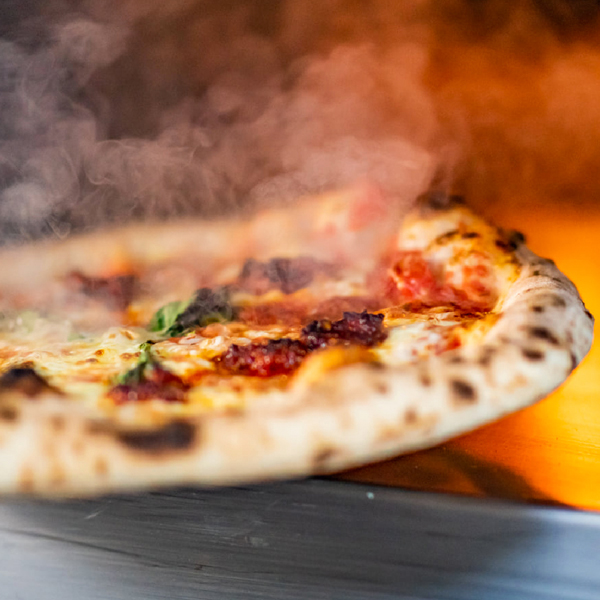 Mostro Pizza Fiery pepperoni served steaming hot Mostro Pizza Fiery pepperoni served steaming hot